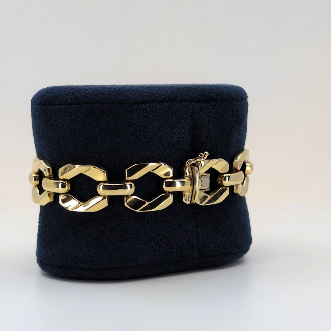 14K Italian geometric gold bracelet with articulated links displayed on a black velvet jewelry stand.