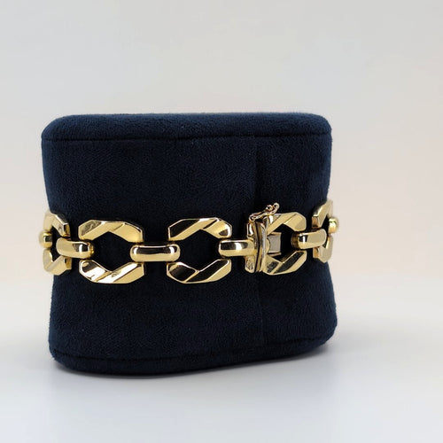 14K Italian geometric gold bracelet with articulated links displayed on a black velvet jewelry stand.