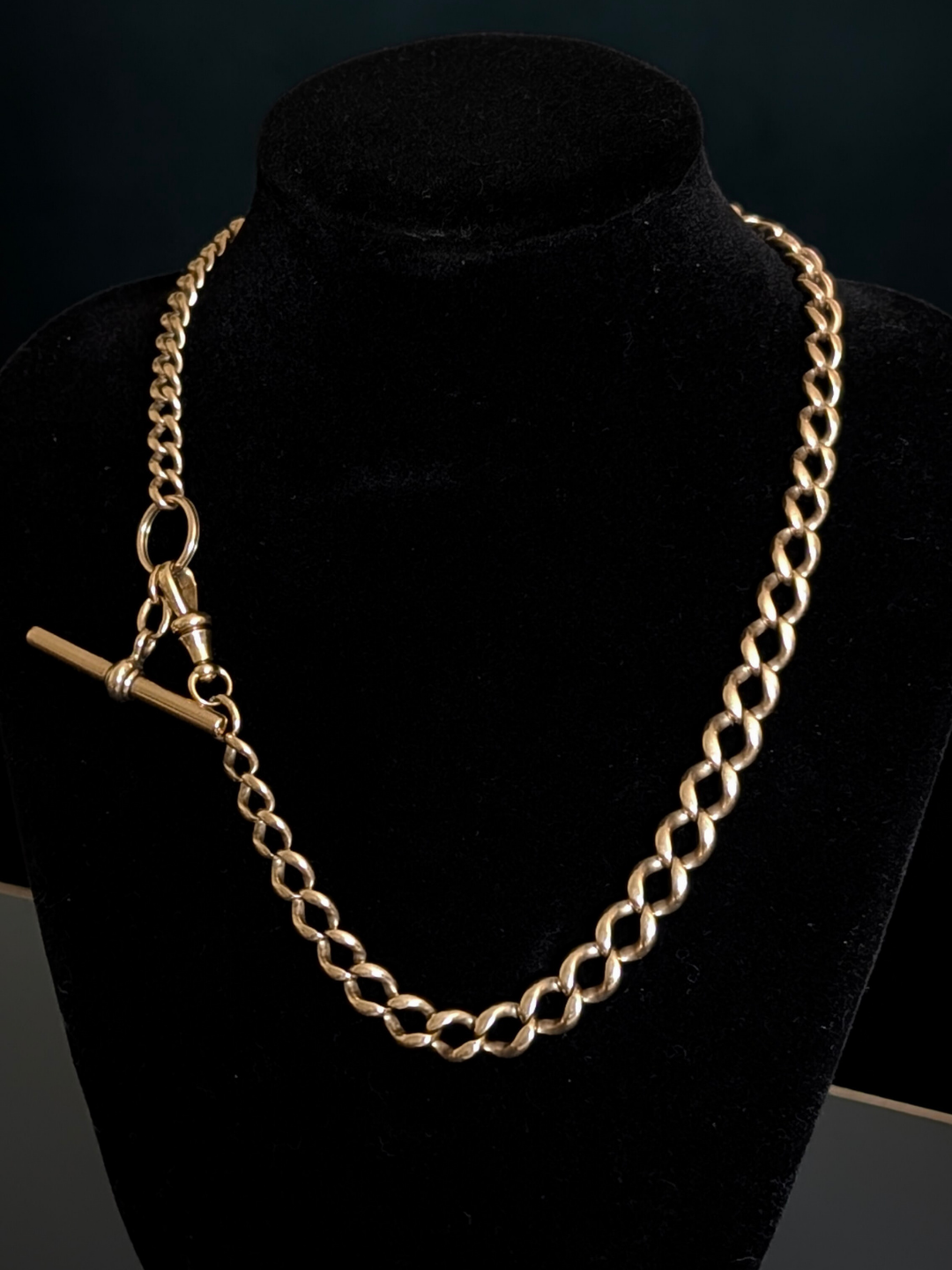 Antique graduated curb watch chain with a dog clip, t-bar, and split ring