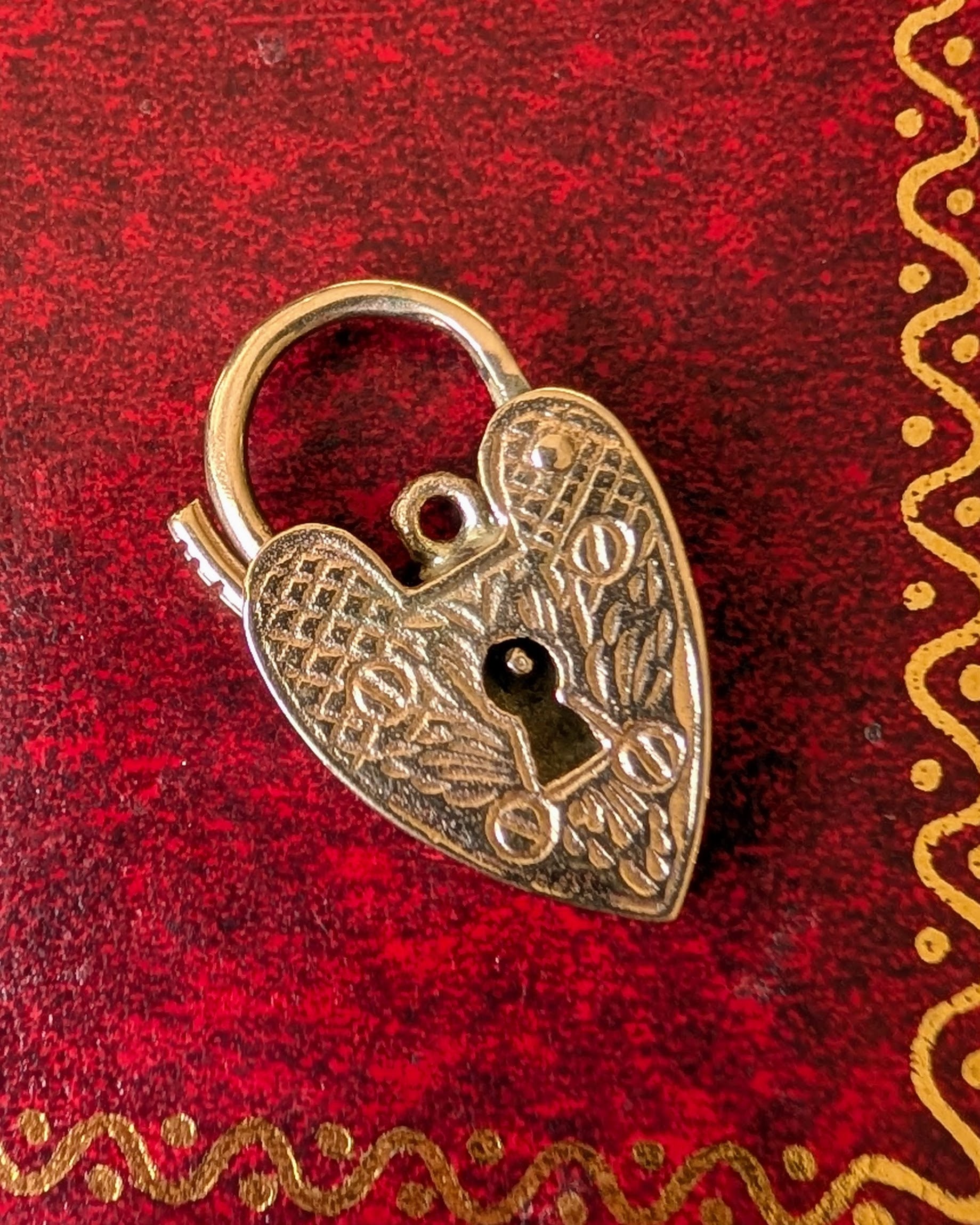 Antique gold heart-shaped padlock etched with angel wings 