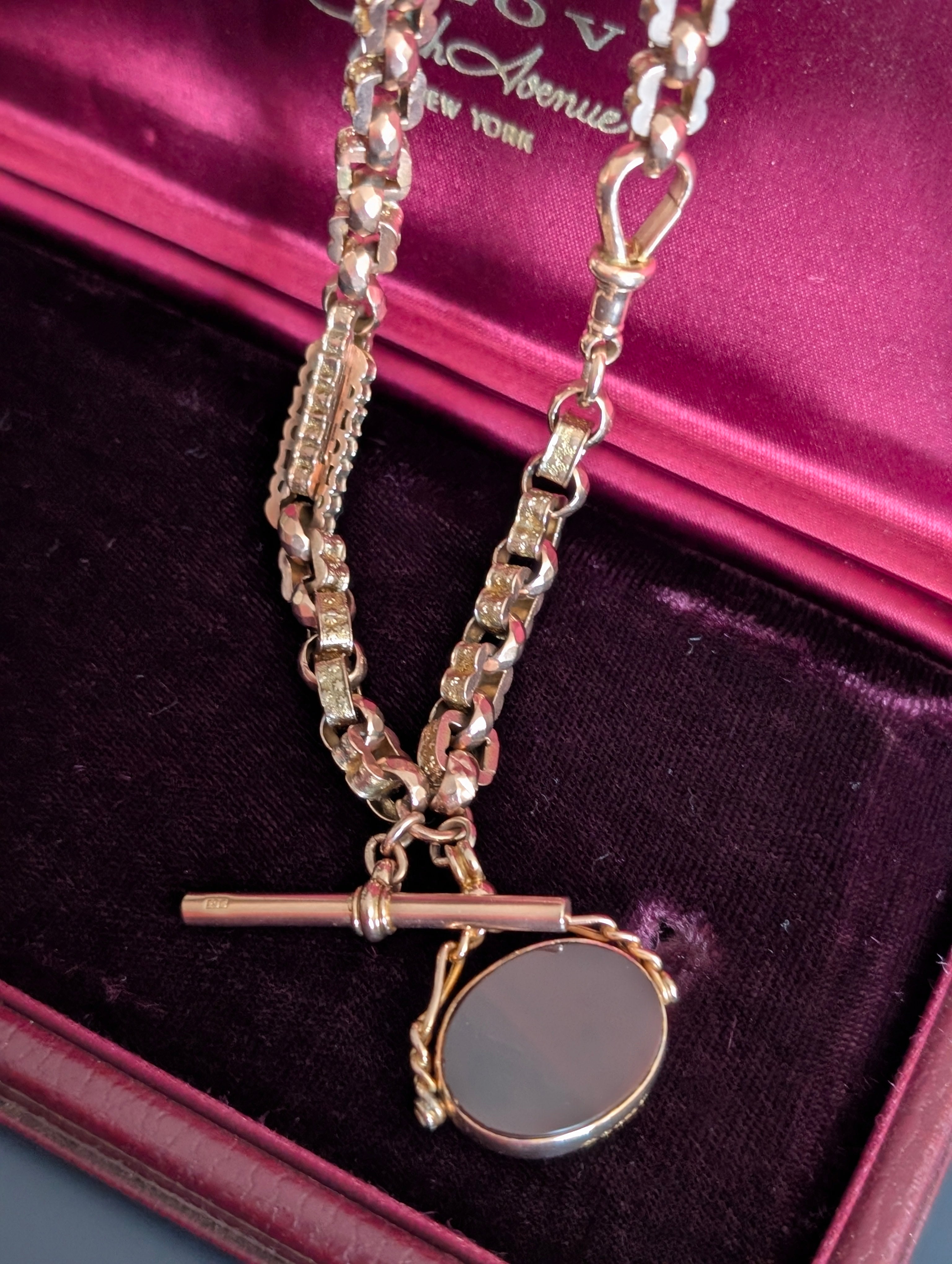 Yellow gold watch chain with fancy links and a carnelian watch fob