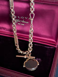 Yellow gold watch chain with fancy links and a carnelian watch fob
