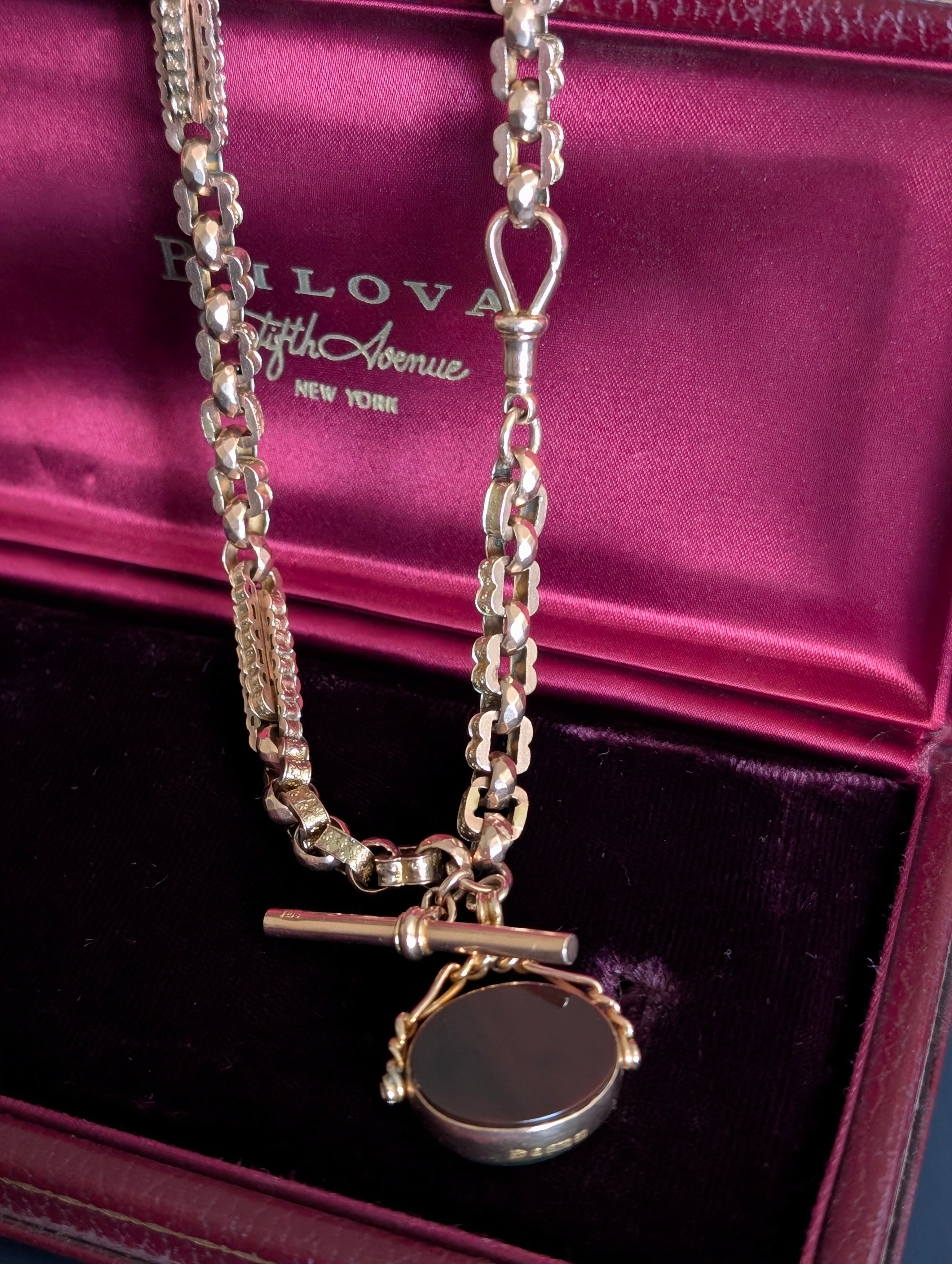 Yellow gold watch chain with fancy links and a carnelian watch fob