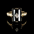 Gold ring with a black stone and diamond design on a black background